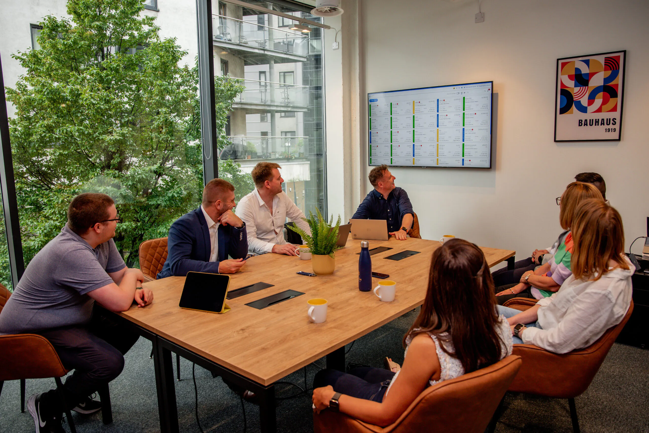 People sat around a table | how to choose construction management software | Digital Beehive